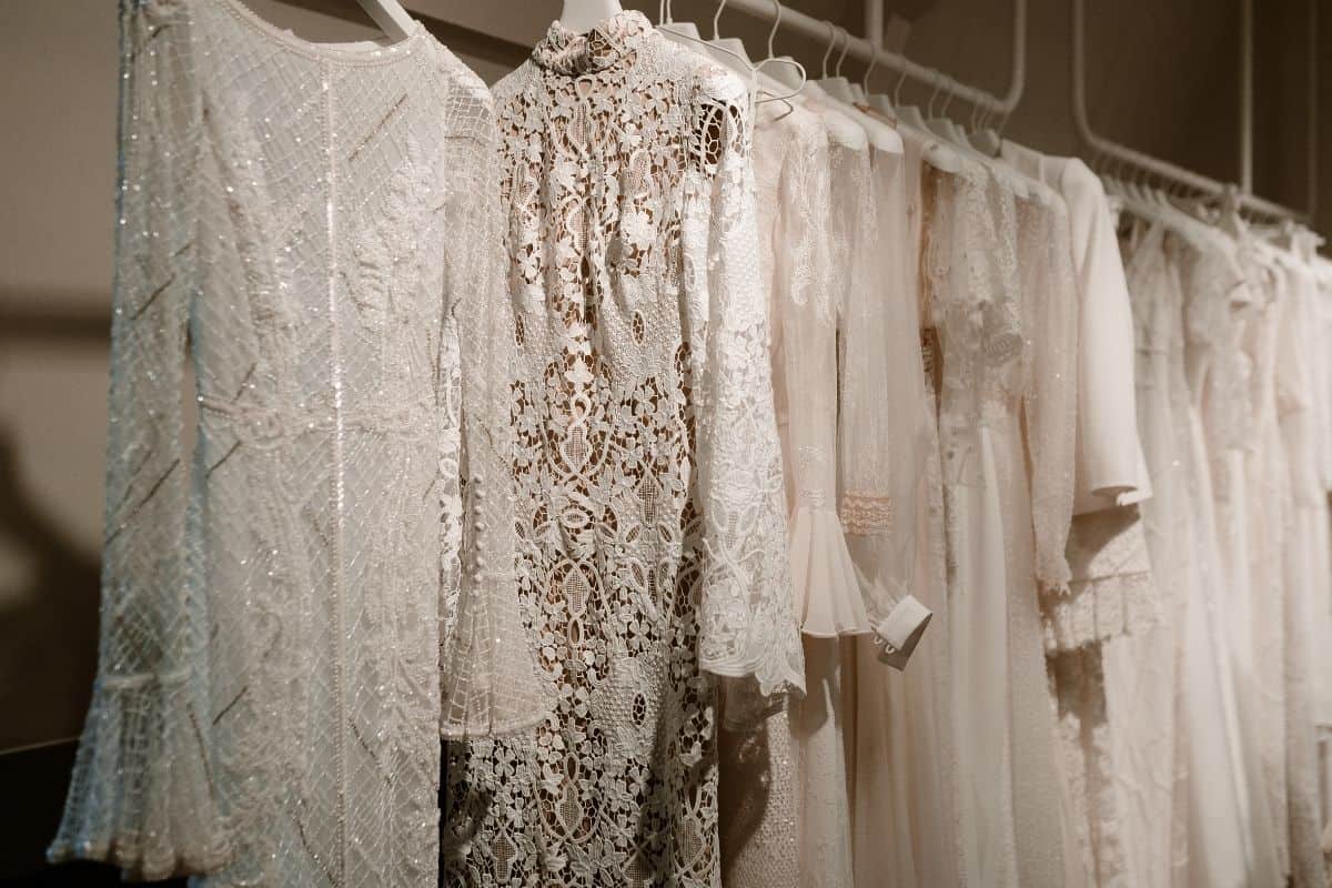 photo with wedding dresses on rack during trunk show with cocktail glasses in front