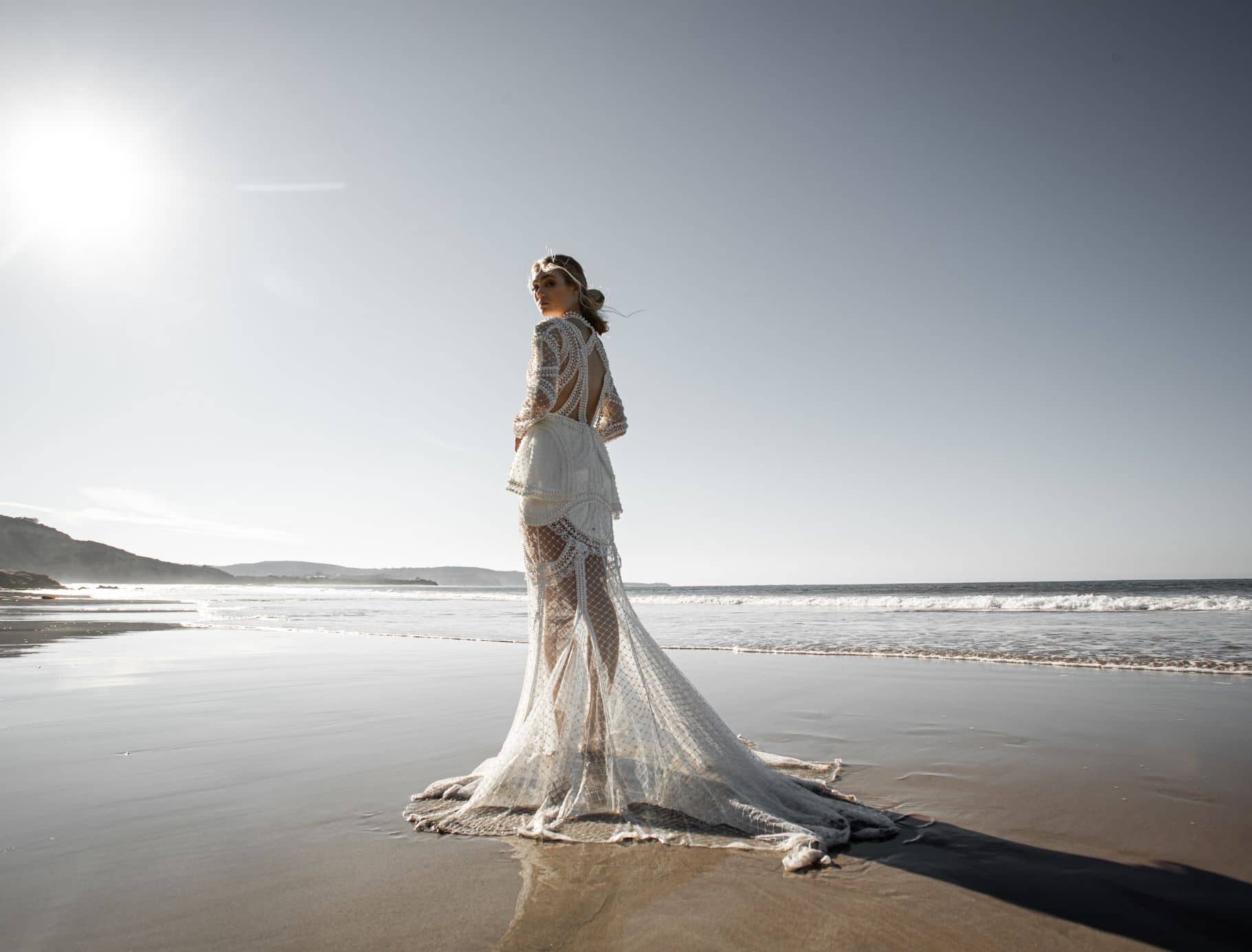 bride on beach in pearl wedding dress