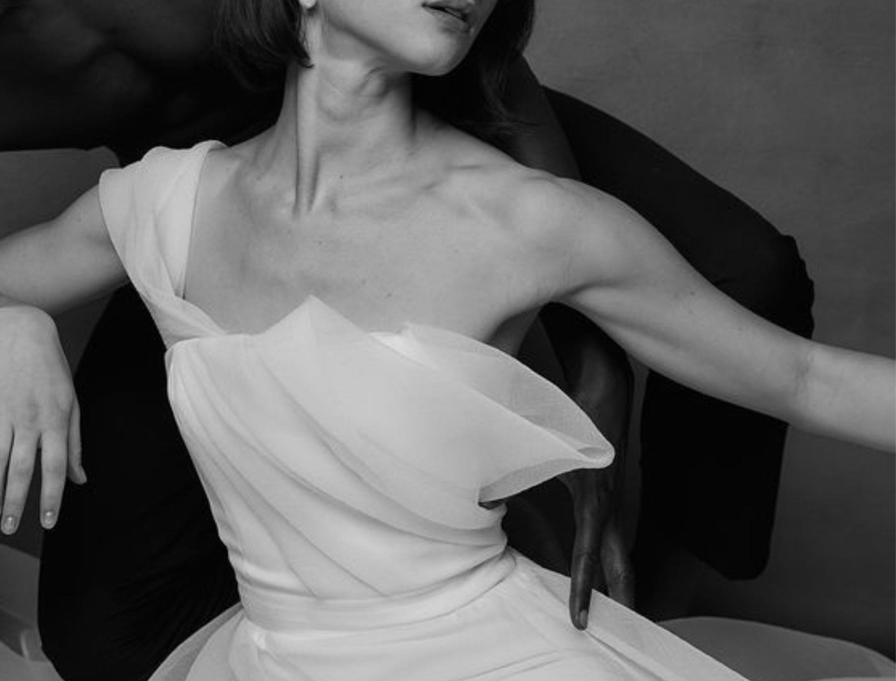 close up photo of modern minimalistic wedding dress with structured tulle off shoulder neckline