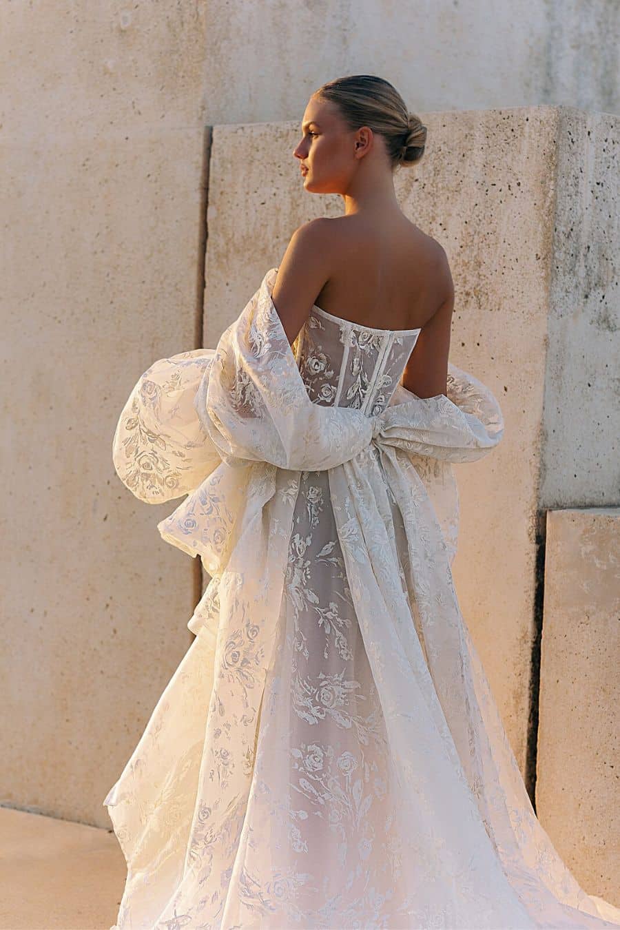 photo of the back of a bride wearing a organza wedding dress
