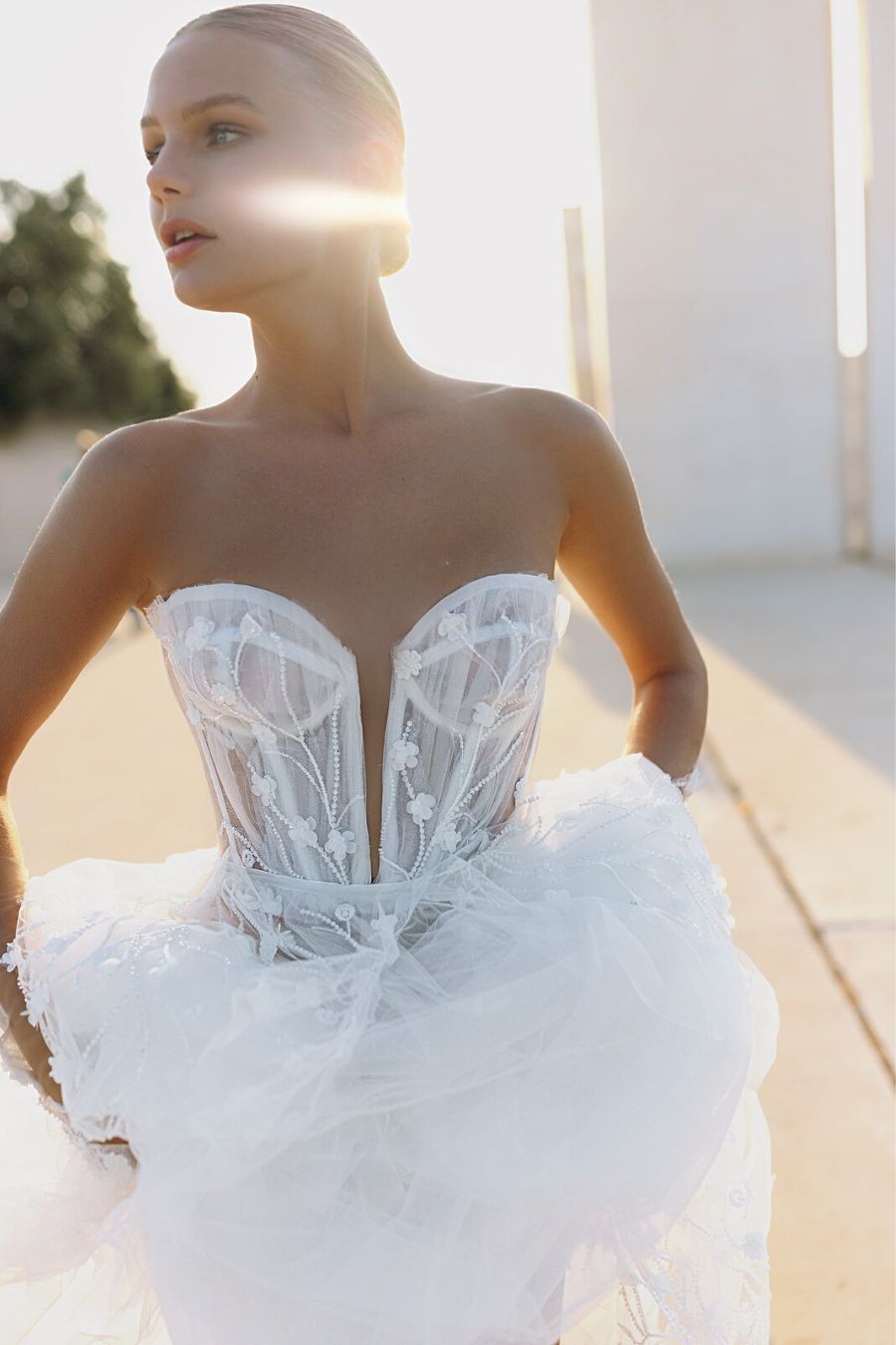 Close up photo of strapless ballgown wedding dress with flower beads and tulle