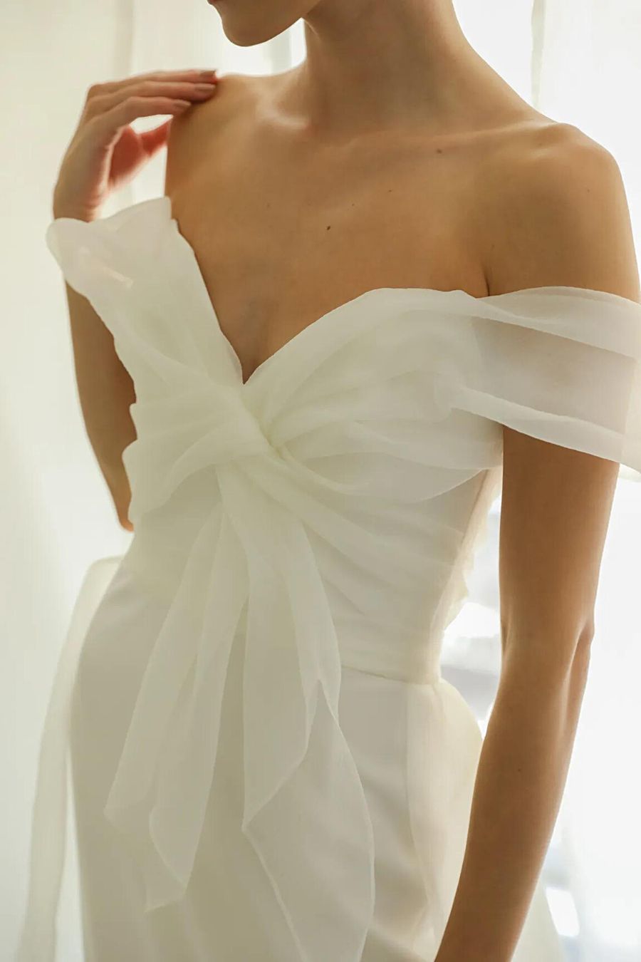 Top details of minimal wedding dress with structured organza top