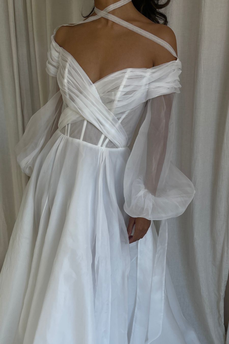 Close up photo of silk aline wedding dress with long silk poofy sleeves